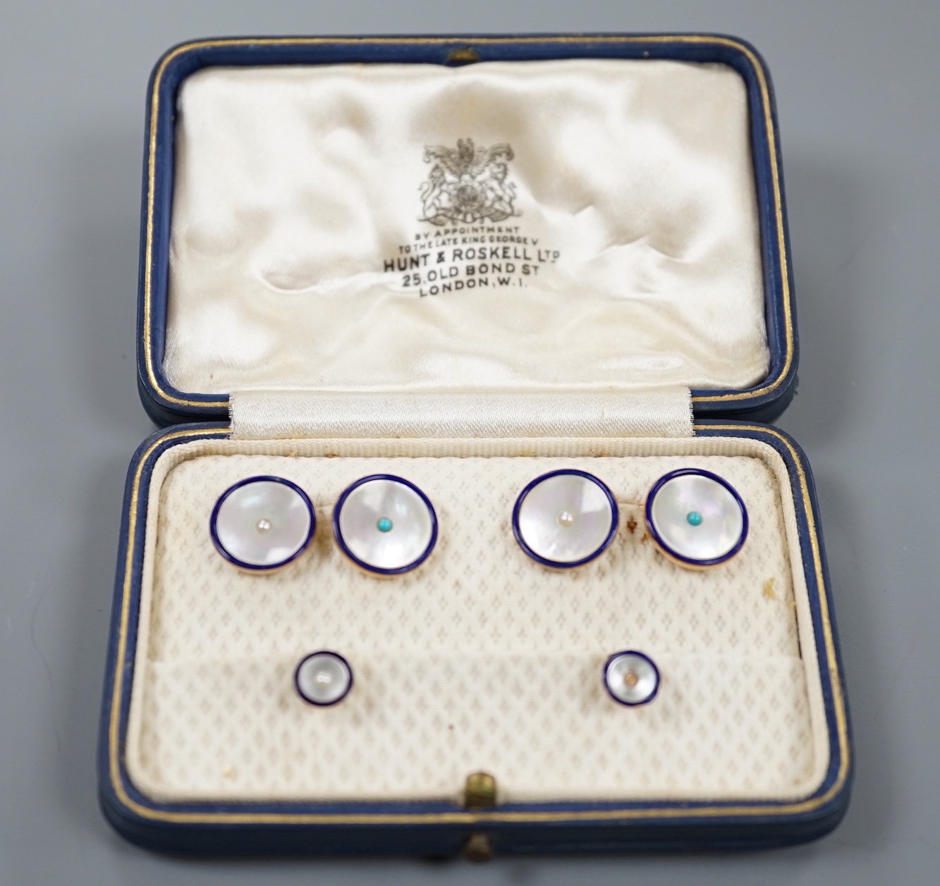 A cased four piece 9ct, mother of pearl turquoise and blue enamel dress stud set, comprising a pair of cufflinks and two studs